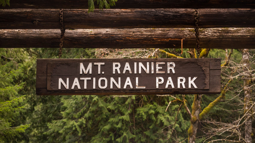 A sign hangs at the entrance to Mount Rainier National Park in Ashford in March 2022.