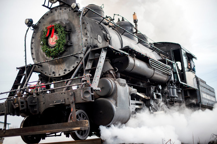 The Chehalis-Centralia Railroad Association's Baldwin-built 2-8-2 steam locomotive rumbles down the tracks as it heads to the front of the Polar Express passenger cars prior to leaving the station in December 2014.
