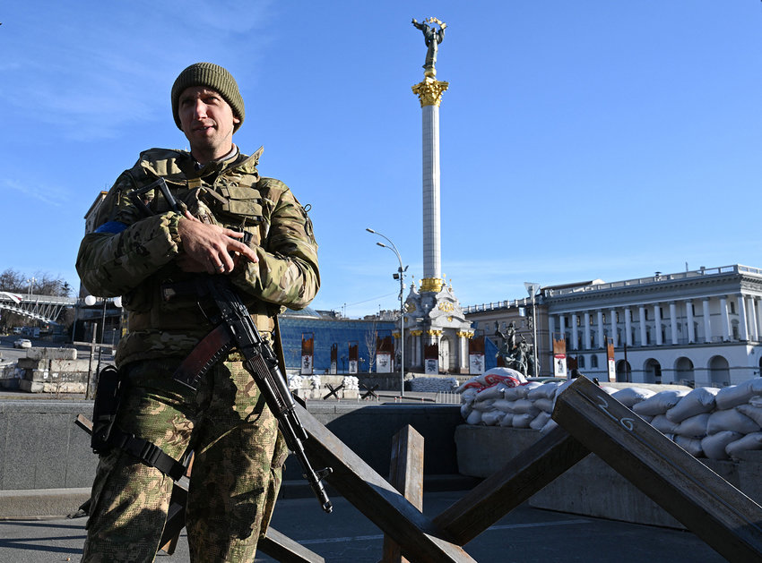 Former Ukrainian tennis man Sergiy Stakhovsky talks with AFP journalists at Independence Square in Kyiv, on March 15, 2022. - Stakhovsky, who famously beat Switzerland's Roger Federer at Wimbledon in 2013, had signed up for Ukraine's military reserves. He patrols to protect Kyiv in military fatigues and with a Kalashnikov assault rifle. (Sergei Supinsky/AFP via Getty Images/TNS)