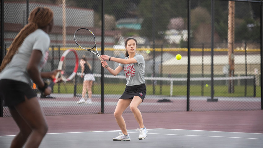 W.F. West's first doubles player Hannah Feaster prepares for an underspin return while her partner Mariama Ceesay calls the serve in against Washougal on Wednesday.