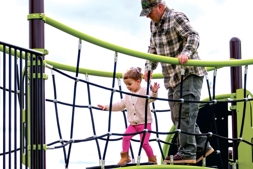 FILE PHOTO &mdash;&nbsp;A little girl and her grandfather walk the shaky bridge at the Chehalis Penny Playground during the first week of spring.