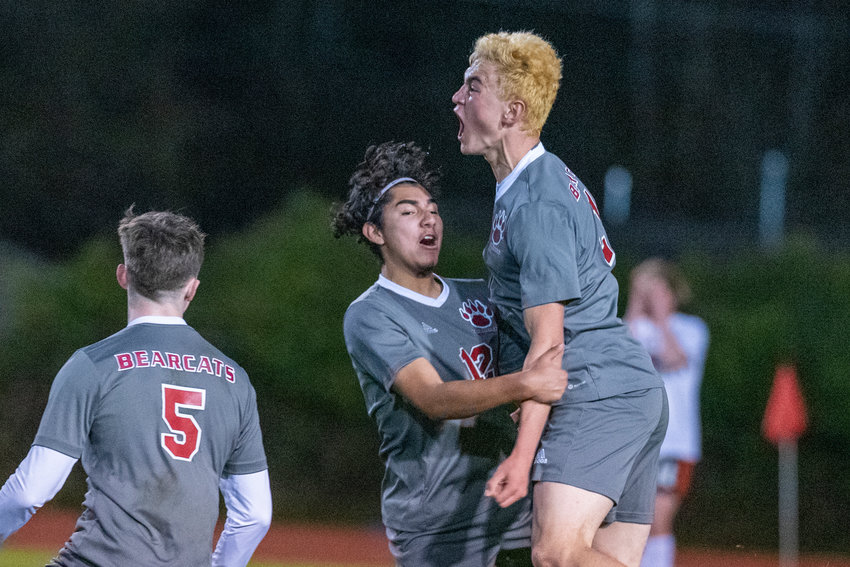 W.F. West's Gideon Priest (21) leaps in celebration with Adan Vargas (12) after Priest's first-half goal to give the Bearcats a 1-0 halftime lead over Centralia at home on March 25.