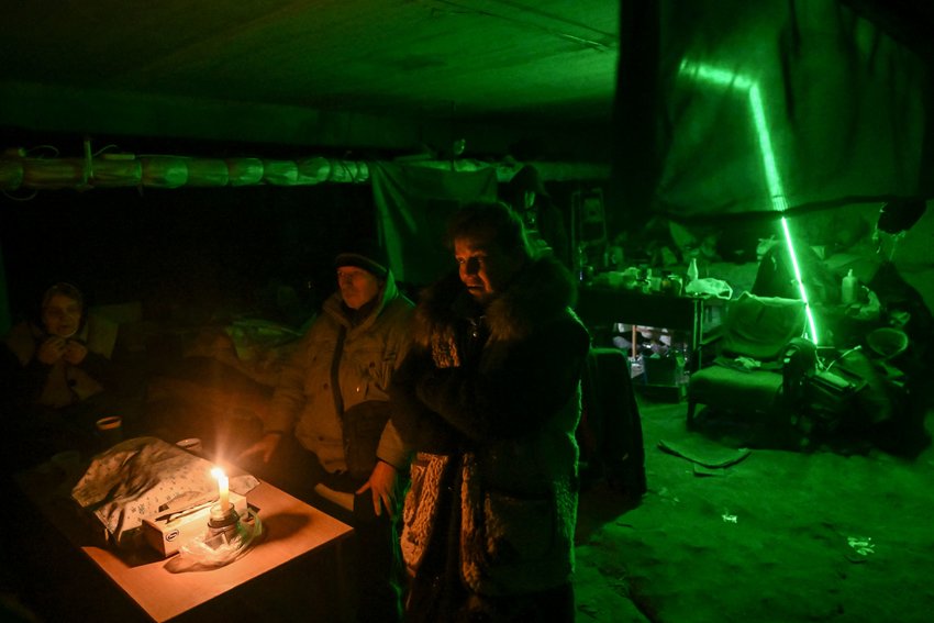 People take shelter in the basement of a school where they have been living for a month, along a front line district of Kharkiv on March 27, 2022. A working-class neighborhood of high-rise blocks on the northeast outskirts of Ukraine's second-largest city, a stone's throw from the first fields of plowed black earth in the countryside. The Russian troops, who have camped a few kilometers away, loot the place every day, with their entire armada. &quot;District 4&quot; is nothing more than a ghost town, a devastated battlefield. (Aris Messinis/AFP via Getty Images/TNS)