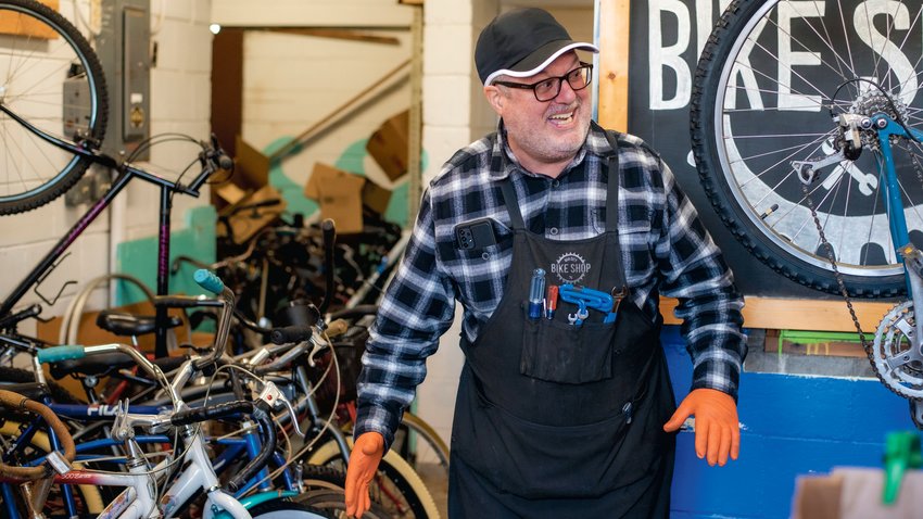 Dave Smith smiles while telling stories of bikes that have been sold and brought back to the Hub City Bike Shop in Centralia.