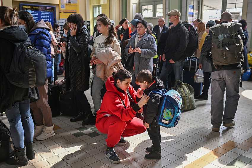 People, mainly women and children, arrive at Przemysl train station after journeying from war-torn Ukraine on March 30, 2022, in Przemysl, Poland. The Polish government has said it may spend &euro;24 billion this year hosting refugees fleeing the war in Ukraine, and is seeking more support from the European Union. With more than 4 million Ukrainian refugees, Poland is now the country with the second-largest foreign refugee population after Turkey. (Jeff J Mitchell/Getty Images/TNS)