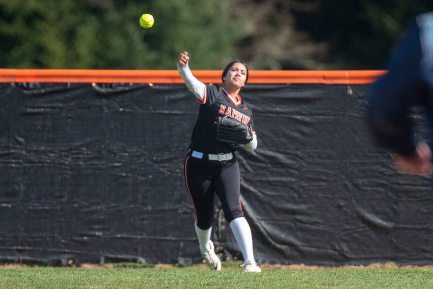 Napavine right fielder Natalya Marcial tosses a ball back to the infield after making a catch near the fence against Toutle Lake on March 31.
