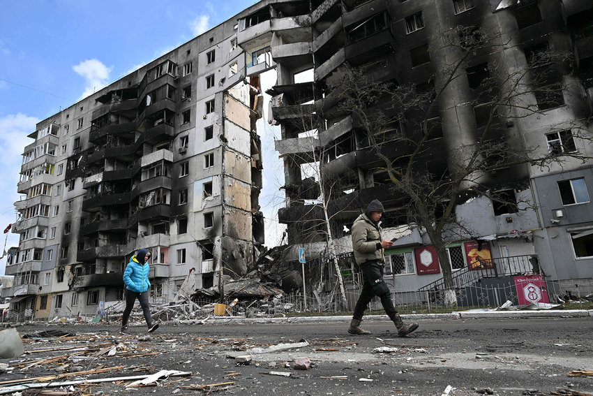 People walk past destroyed buildings in the town of Borodianka, northwest of Kyiv, Ukraine, on Monday, April 4, 2022. (Sergei Supinsky/AFP via Getty Images/TNS)