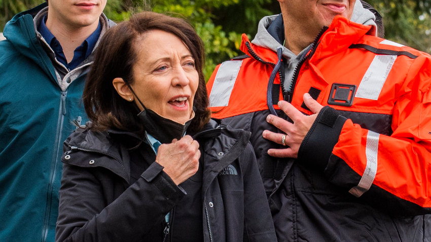U.S. Senator Maria Cantwell lowers her mask as she is greeted before touring the Nisqually River last April.