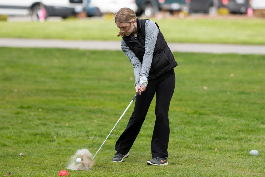 W.F. West's Kendall Rasumussen kicks up water as she tees off during a league match against Centralia at Newaukum Valley Golf Course on April 13.