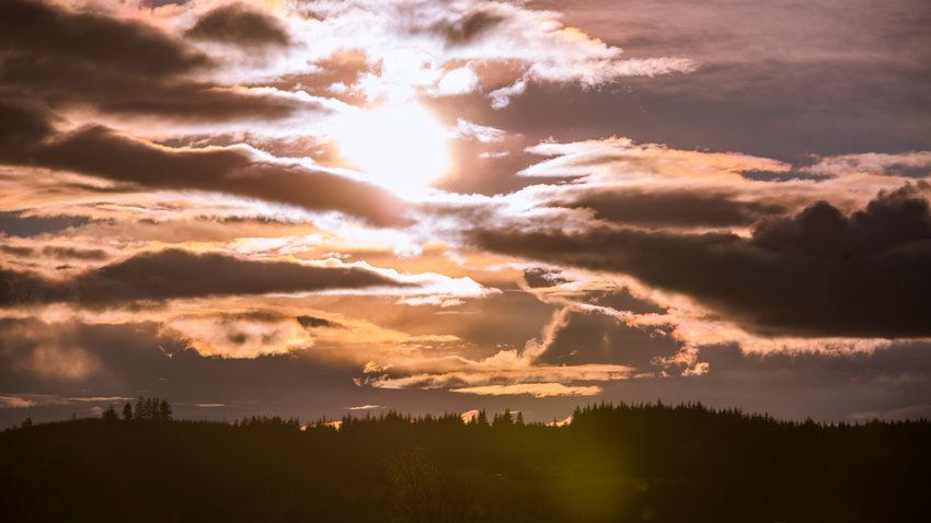 FILE PHOTO &mdash; The sun sets through clouds over Chehalis.