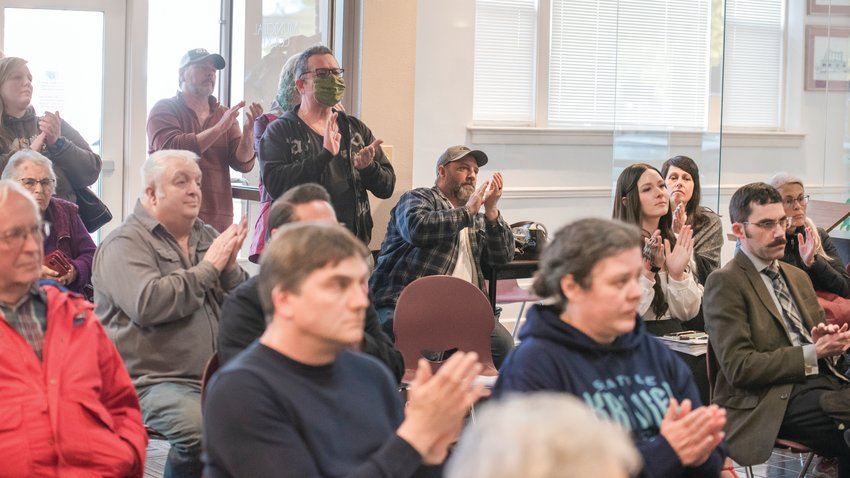Community members clap as attendees speak out against the sale of the City of Centralia&rsquo;s decommissioned golf course property near Seminary Hill.
