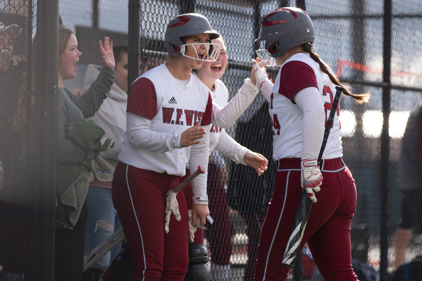 W.F. West's Staysha Fluetsch (left) celebrates with Savannah Hawkins (right) after Hawkins scored a run against Tumwater at Recreation Park in Chehalis April 15.