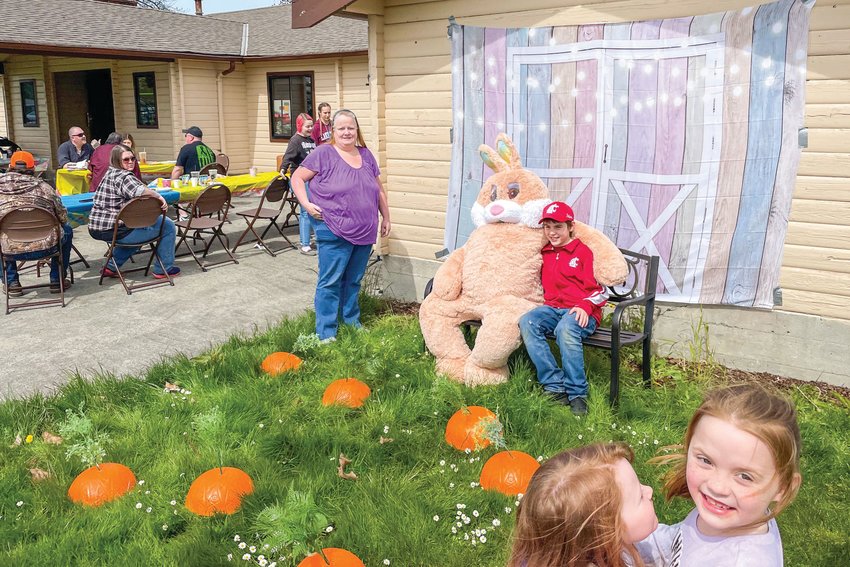 A bunny poses for photos with kids at Penny Playground outside the Virgil R. Lee Community Building in Chehalis on Easter Sunday.