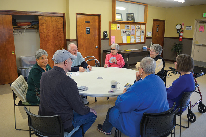 Michelle Phillips, far left, smiles as she plays pinochle with fellow seniors at the Battle Ground   Senior Center on April 5.