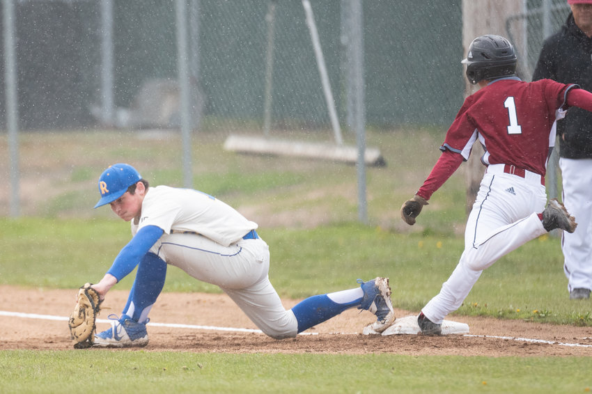 Rochester first baseman Garren Smith makes a play to get W.F. West's Brock Bunker out at first April 19.