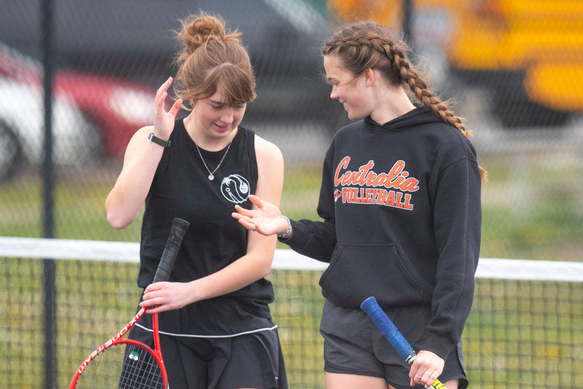 Centralia's Liza Hopkins, left, and Maddie Corwin high-five during a No. 1 doubles match at home against Black Hills on April 19.