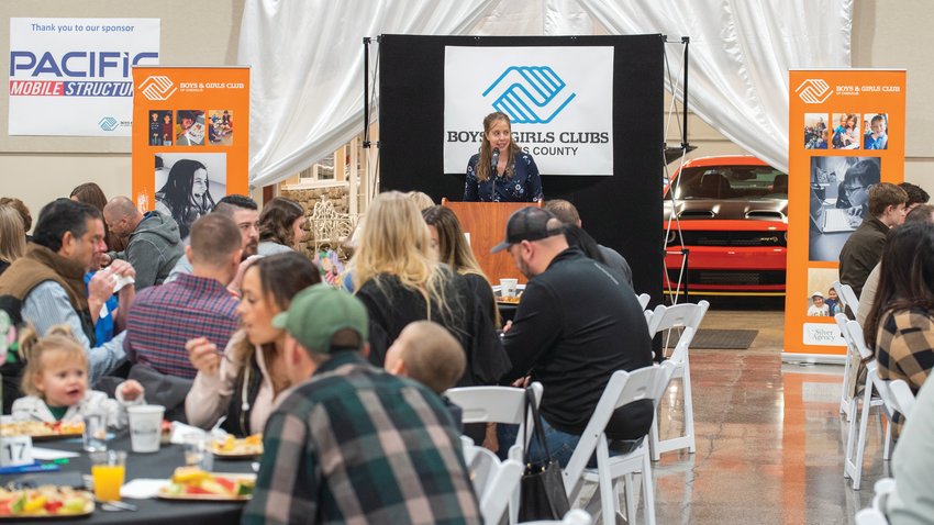 iExecutive Director Lauren Day welcomes attendees to &quot;The Most Important Meal of the Year&rdquo; event hosted by the Boys and Girls Club of Lewis County at the Jester Auto Museum.