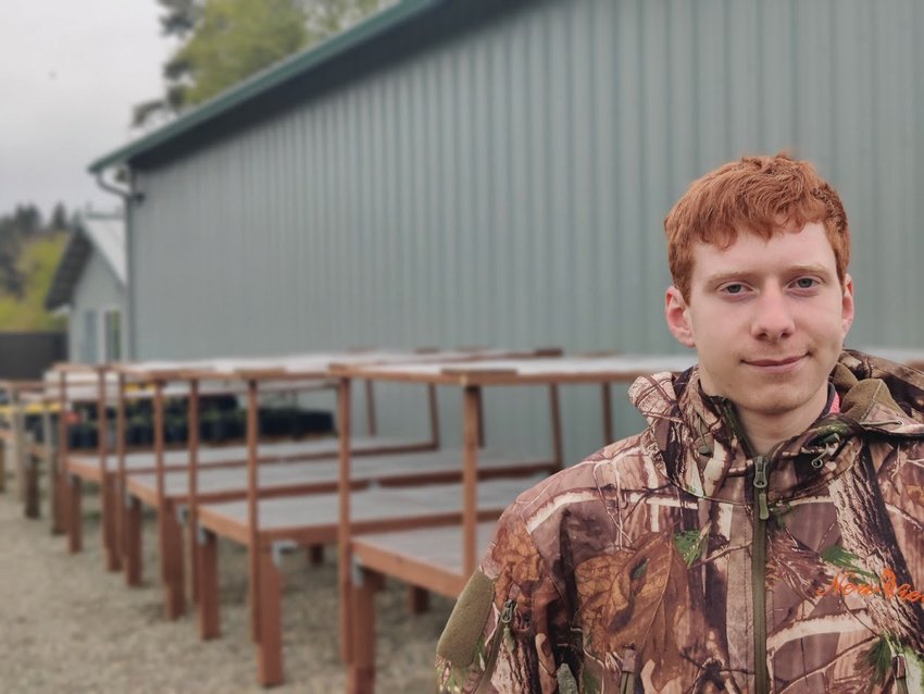 Boy Scout Jesse Ervin poses in front of the tables he&rsquo;s built as part of his Eagle Scout project for the Scatter Creek Wildlife Area.