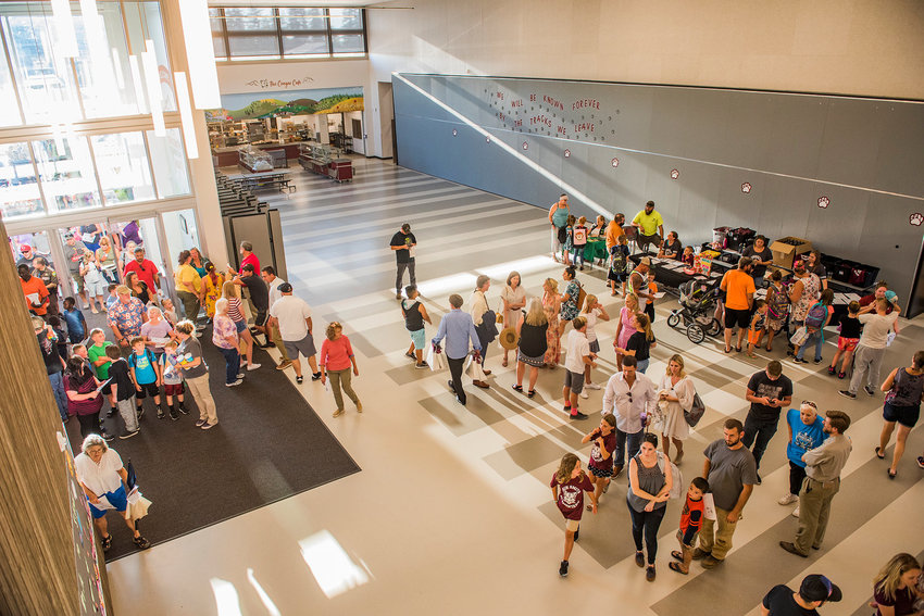 FILE PHOTOS &mdash; Attendees flood into Orin C. Smith Elementary during the grand opening in 2019.