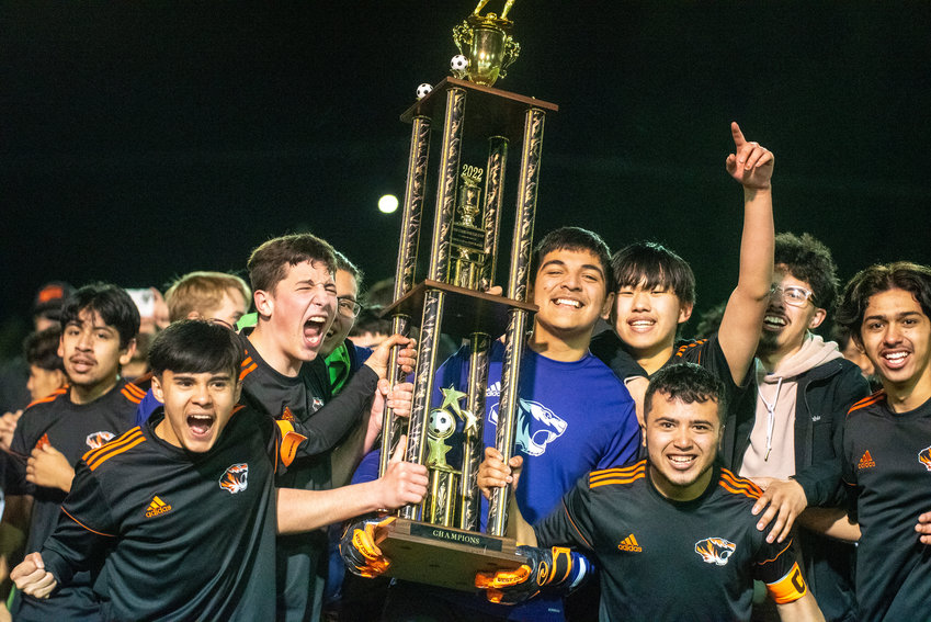 Centralia boys soccer players hoist The Chronicle Cup trophy after beating rival W.F. West in penalty kicks twice to claim the first-ever Chronicle Cup on Friday at Tiger Stadium.