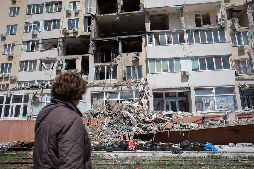 A resident whose apartment got destroyed as a result of a missile strike on a residential building, looks at the work of the rescue team on April 25, 2022, in Odessa, Ukraine. Ukrainian forces, as well as civilian Odessans, remain on guard against a potential Russian advance on this historic port city, whose capture could help give Russia control of Ukraine's southern coast. But given Russia's setbacks in this two-month-long war, including the sinking of its Black Sea Fleet's flagship Moskva, analysts regard a full-scale attack on Odessa to be unlikely. (Anastasia Vlasova/Getty Images/TNS)