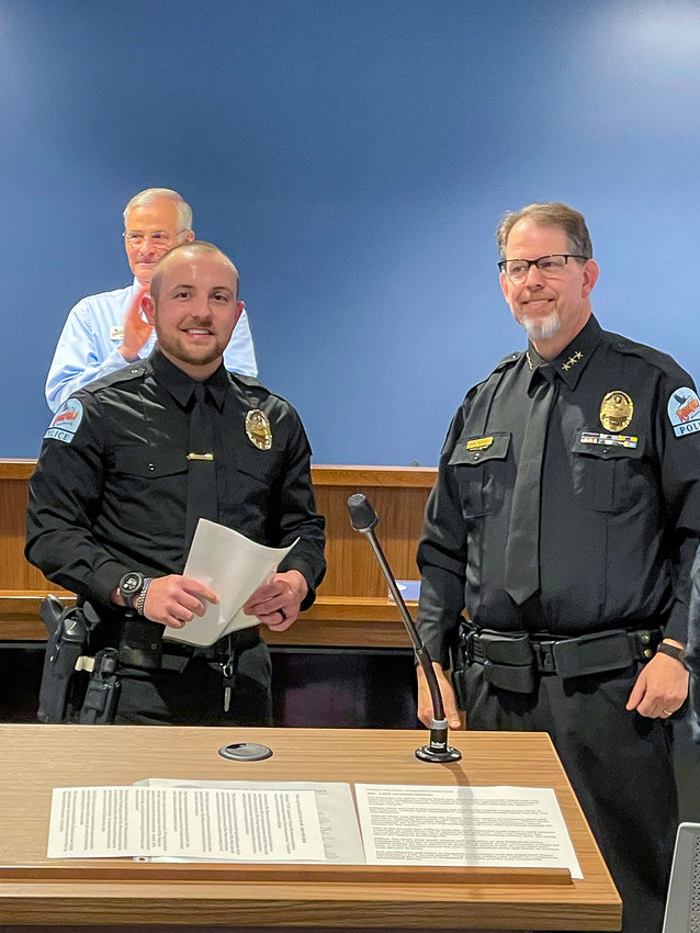 Ridgefield Police Officer Nic Siem, left, receives a lifesaving award from Police Chief John Brooks during a ceremony for two officers at Ridgefield City Council&rsquo;s April 14 meeting.