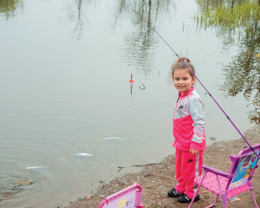 FILE PHOTO &mdash;&nbsp;A young girl smiles after catching two rainbow trout during the Borst Park Fishing Derby in Arpil 2022.