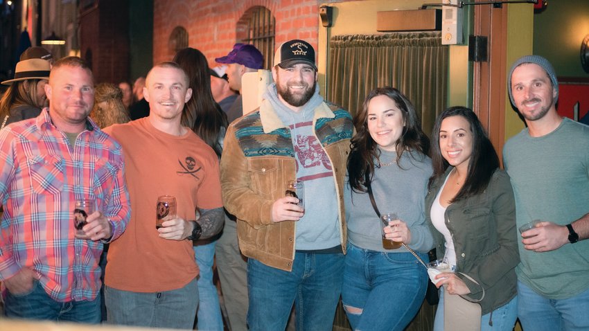 From left, Cameron Clark, Blake Britton, Tayler Brush, Jessica Britton, Ally Burrell and Danny Hogg smile and pose for a photo during the McMenamins Olympic Club Brewfest event Saturday night in Centralia.