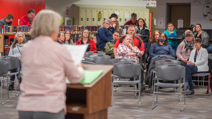 Attendees of a school board meeting listen in during public comment Monday afternoon.