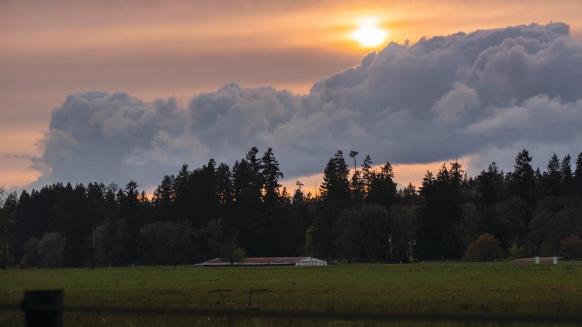The sun sets behind clouds over Tenino.