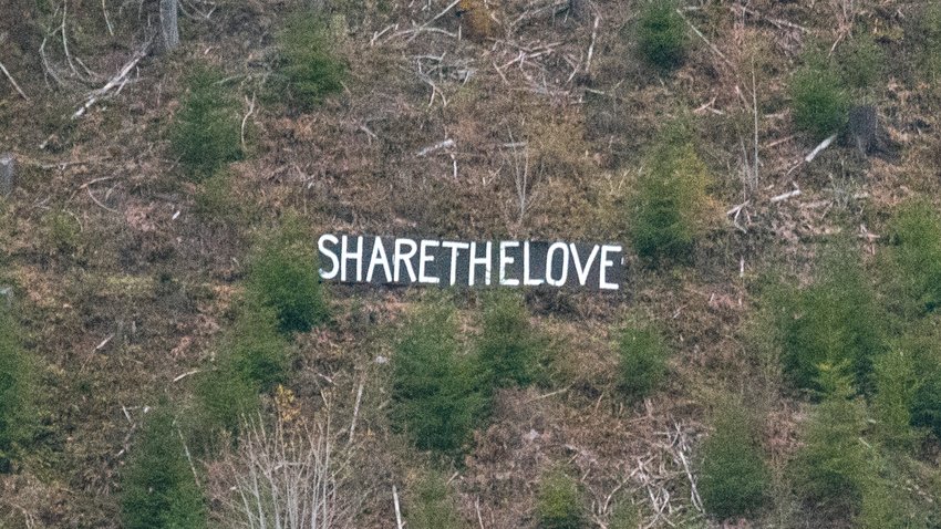 A handmade sign seen from U.S. Highway 12 in Randle reads &ldquo;Share The Love&rdquo; on Thursday evening.