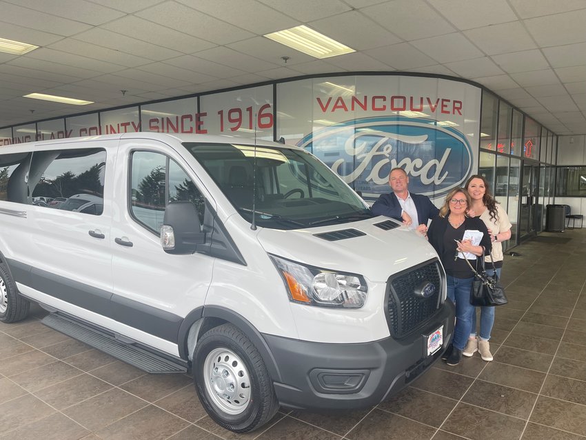From left to right, Monte Phillips, Marcy Sprecher, and Jessica Rudisill stand next to one of the Rocksolid Teen Community Center&rsquo;s new vans at Vancouver Ford.