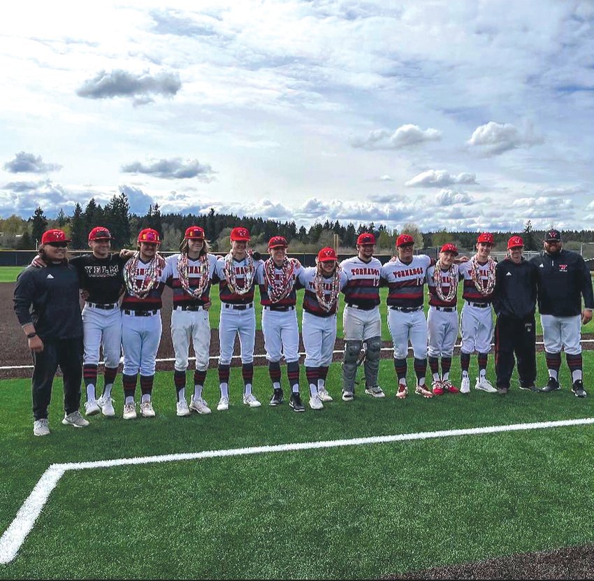 Yelm&rsquo;s coaching staff poses for a picture with the team&rsquo;s seniors prior to their matchup with Rainier on April 29.