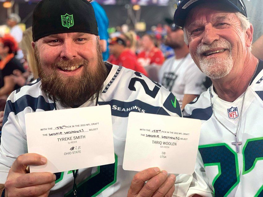 Brian Edwards (left) and Phil Edwards (right) display the Seahawks draft cards following their selections.