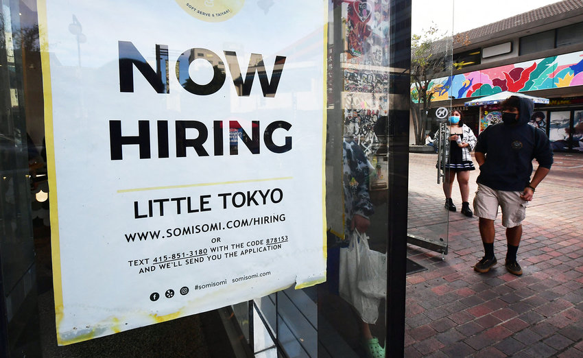 A &quot;now hiring&quot; sign is posted in the window of an ice cream shop in Los Angeles, California on Jan. 28, 2022. (Frederic J. Brown/AFP via Getty Images/TNS)