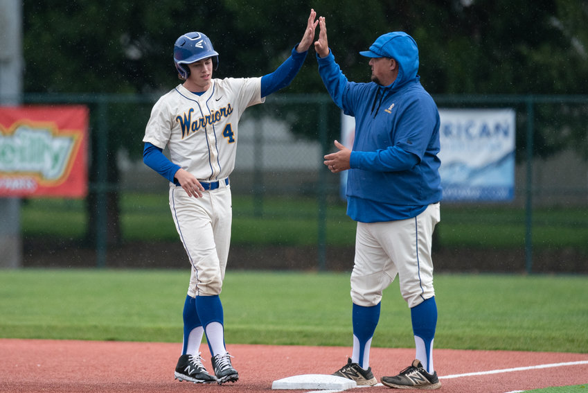 Rochester's Ledger Anderson high-fives coach AJ Easley against Black Hills in a play-in game at the Regional Athletic Complex in Lacey May 6.
