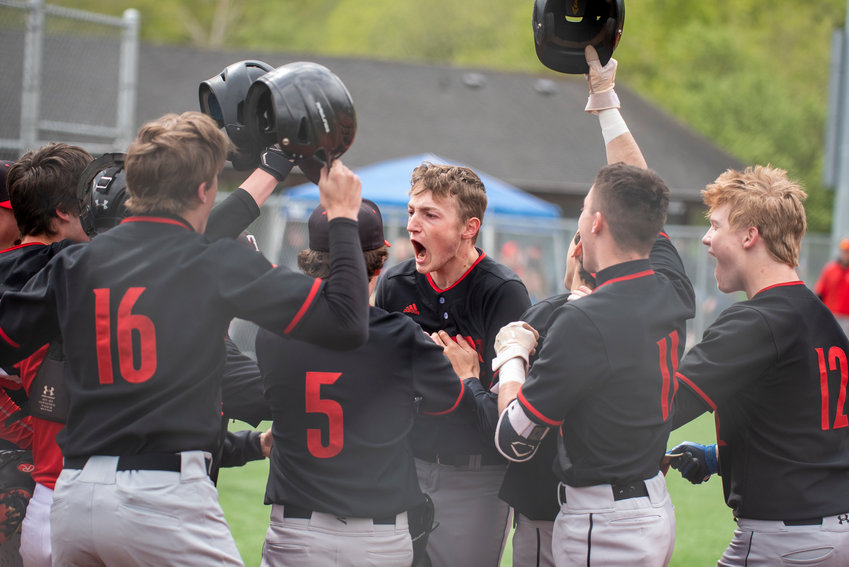 Toledo's Caiden Schultz, middle, yells in celebration after hitting a home run against Wahkiakum during the 2B District 4 playoffs in South Bend on Saturday, May 7.