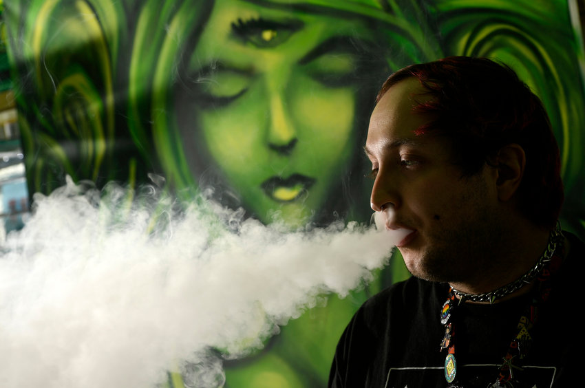 Darren Blake, who works at Myxed Up Creations, uses a vaping product at the store in Denver on Wednesday, Oct. 20, 2021. (Helen H. Richardson/The Denver Post/TNS)
