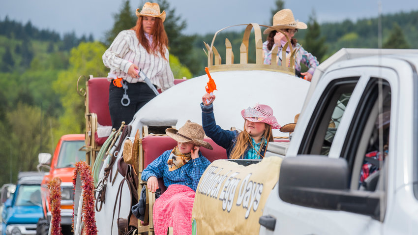 Prop guns are held up from the Winlock Egg Days float during the Vader May Day Parade in May.