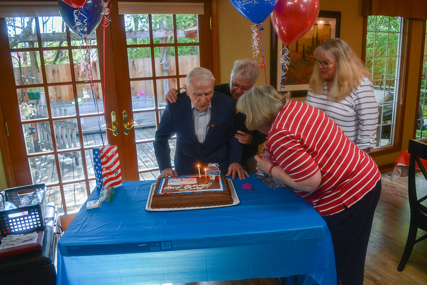 William &ldquo;Lucky&rdquo; Mullins blows out the candles on his birthday cake with support from his daughters Jaylene Mullins and Cindy Richert, and their friend Ginnie Bush during his birthday party in Vancouver on May 4.