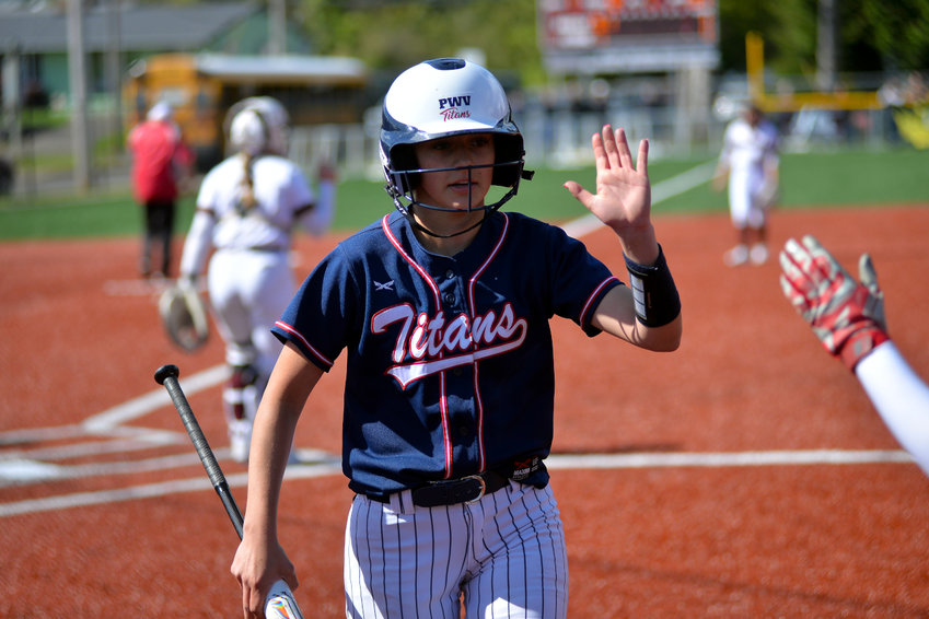 Pe Ell-Willapa Valley's Dani Shannon gets a high five after scoring a run during the Titans' 7-5 win over Montesano on Monday at Dick Tagman Field in Montesano.