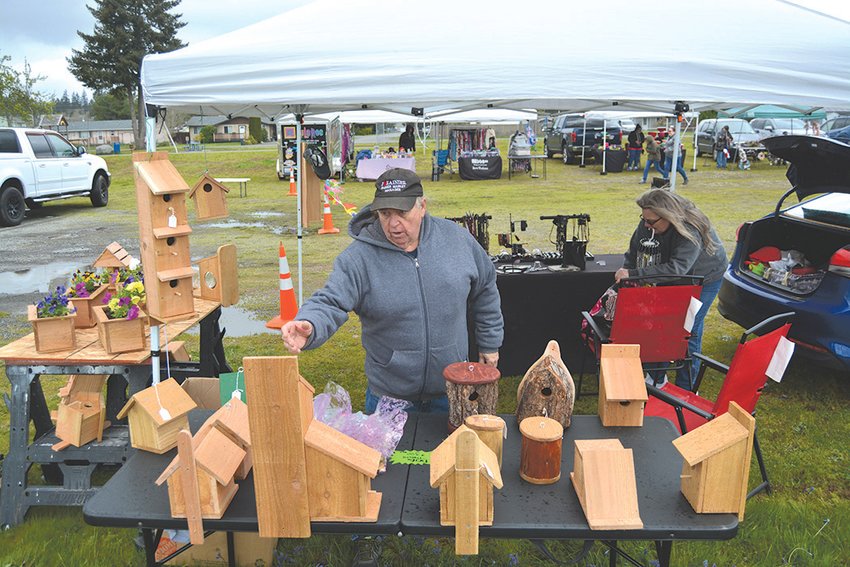 Kevin Pettit, an organizer of the Rainier Saturday Market, stands at his booth which features handmade bird houses on May 7.
