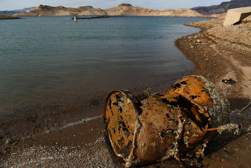 A rusted metal barrel, near where a different barrel was found containing a human body, sits exposed on shore during low water levels due to the West's drought, at the Lake Mead Marina on the Colorado River in Boulder City, Nevada, on May 5, 2022. (Patrick T. Fallon/AFP/Getty Images/TNS)