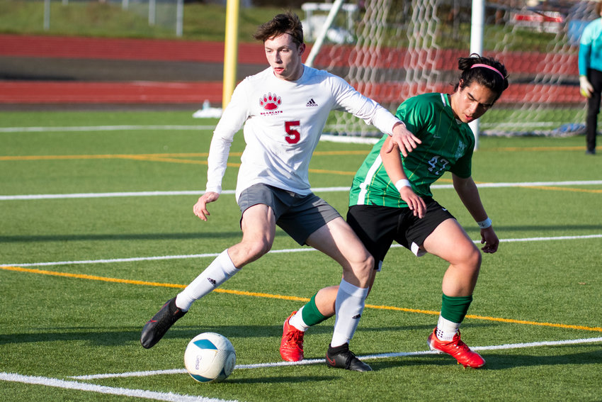 W.F. West's Cody Pennington (5) battles for the ball against Tumwater's Keegan Trubia (47) during the district semifinals on May 12.