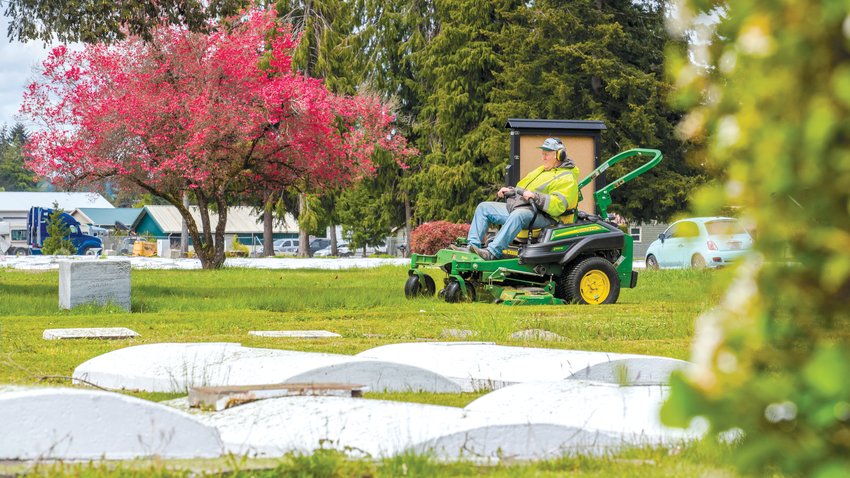 Tim O&rsquo;Hara mows grass at the Greenwood Memorial Cemetary in Centralia on Friday. O&rsquo;Hara lives in Olympia and has worked for the Centralia Parks Department for approximately 30 years.
