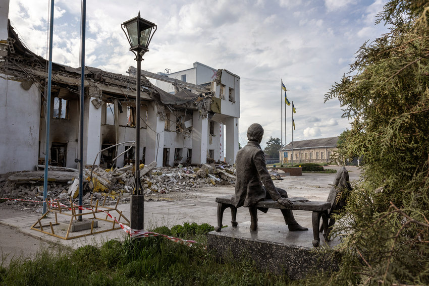 A sculpture of Ukrainian national hero and bard Taras Shevchenko sits near the ruins of the local Palace of Culture on Saturday, May 14, 2022, in Dergachi, Ukraine. (John Moore/Getty Images/TNS)