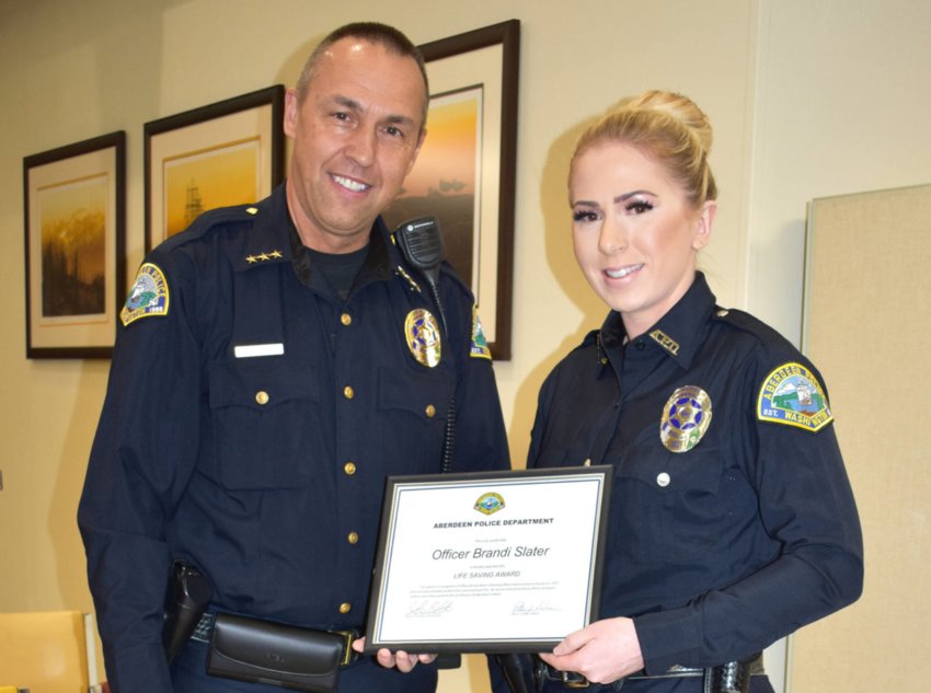 Aberdeen Police Department Chief Steve Shumate bestows the department&rsquo;s &ldquo;Lifesaving Award&rdquo; to fellow APD Officer Brandi Slater after he relayed the story about the call that showed Slater&rsquo;s mettle. Slater, who&rsquo;s been with APD for five years, called her save on Thursday morning, Jan. 13, 2022, &ldquo;a scary moment.&rdquo;