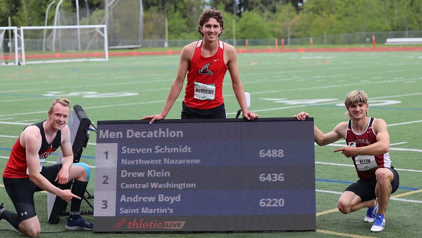 From left to right, Andrew Boyd, Steven Schmidt, and Drew Klein pose with the results of the Great Northwest Atlantic Conference track and field decathlon on May 3.