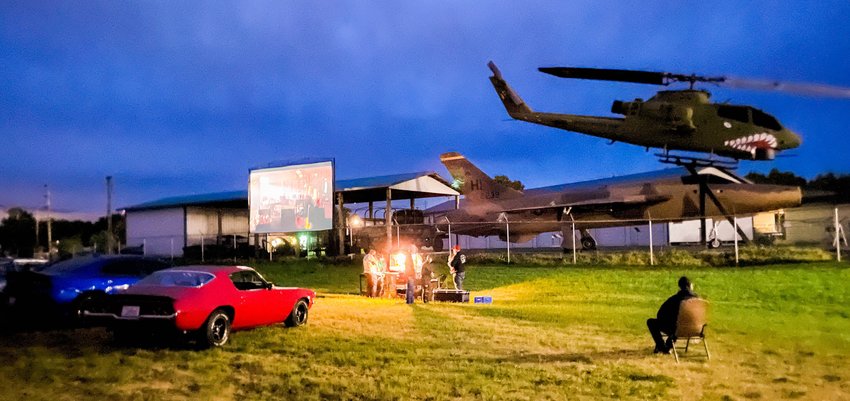 Vehicles park as attendees line up for popcorn in Chehalis while the movie &ldquo;Seabiscuit&rdquo; plays on a screen during an event hosted the Veterans Memorial Museum Saturday night.