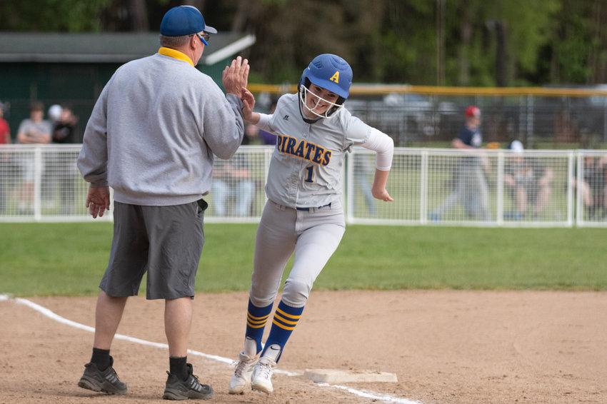 Adna's Brooklyn Loose high-fives coach Bruce Pocklington after hitting a home run against PWV in the 2B District 4 softball championship game at Fort Borst Park in Centralia May 21.